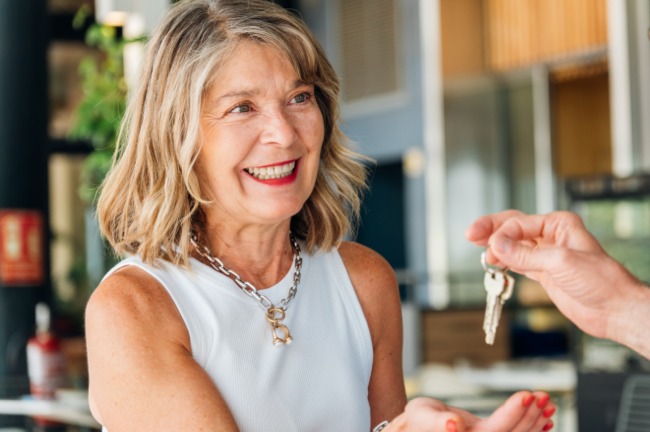 Woman smiling receiving some keys