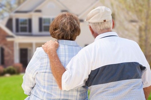 A senior couple looking at a house.