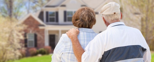 A senior couple looking at a house
