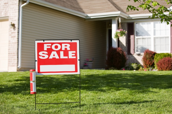 For Sale Sign in Homeowner Yard